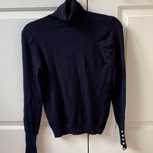 Navy turtleneck with pearl buttons